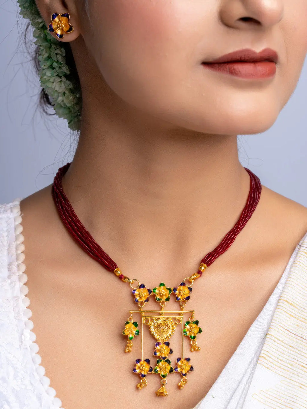 LOOK AND ADORN gold plated floral necklace and matching earrings with colorful stones on woman