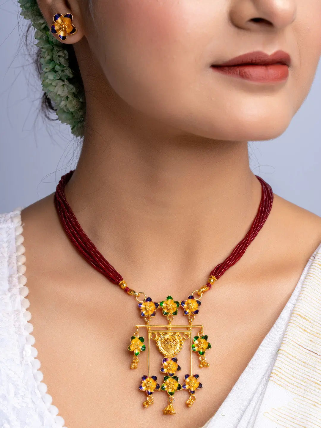 LOOK AND ADORN gold plated floral necklace and matching earrings with colorful stones on woman