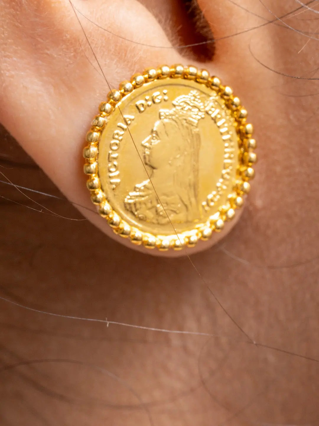 Close-up of gold plated necklace set featuring a coin design earring from LOOK AND ADORN