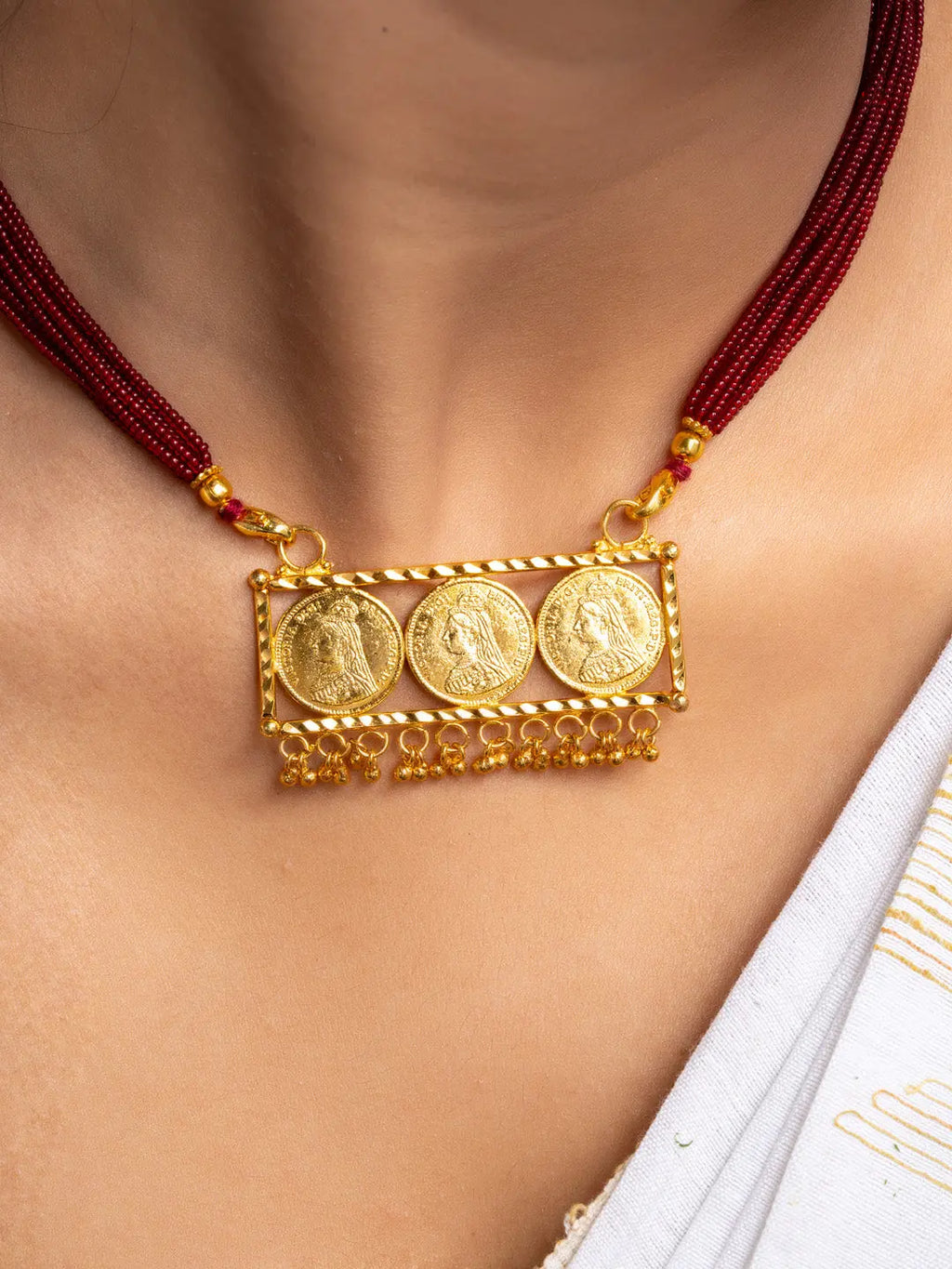 LOOK AND ADORN gold plated necklace set with intricate coin pendants and red beaded strands on neck
