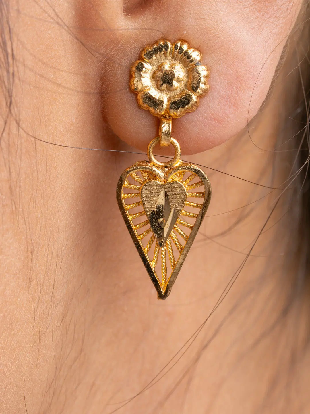 Close-up of gold plated earring from LOOK AND ADORN gold plated necklace set featuring intricate floral and heart design
