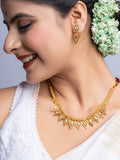 Gold Plated Necklace Set with intricate design worn by woman in traditional attire and floral hair accessory