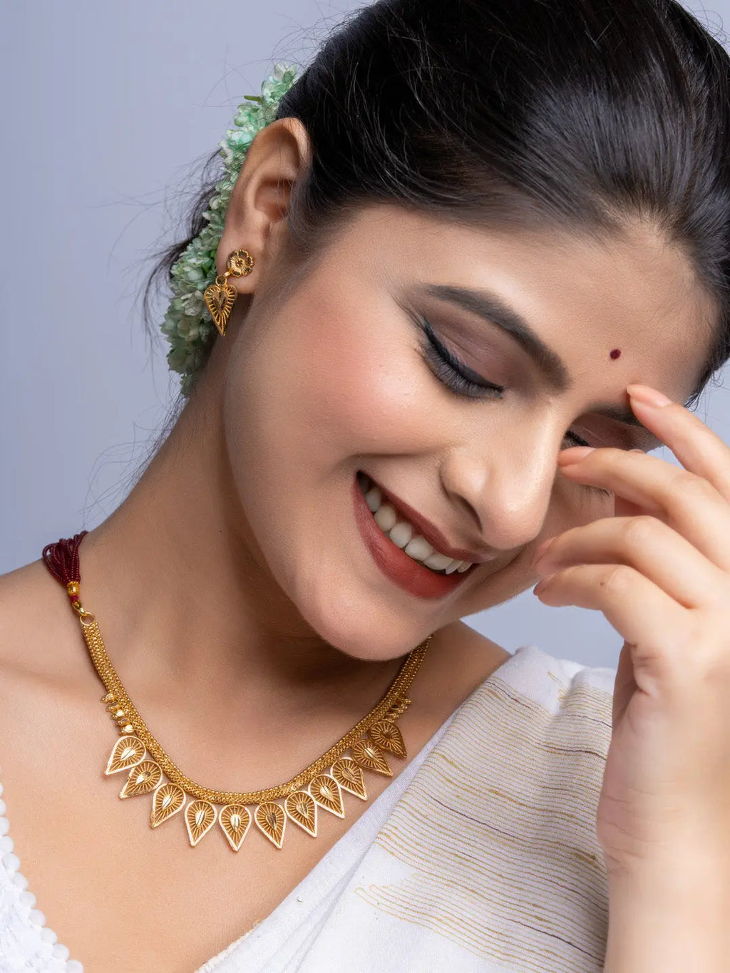 Woman wearing elegant Gold Plated Necklace Set and matching earrings from LOOK AND ADORN