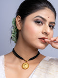 Woman wearing LOOK AND ADORN gold plated pendant on black multi-strand necklace with traditional attire