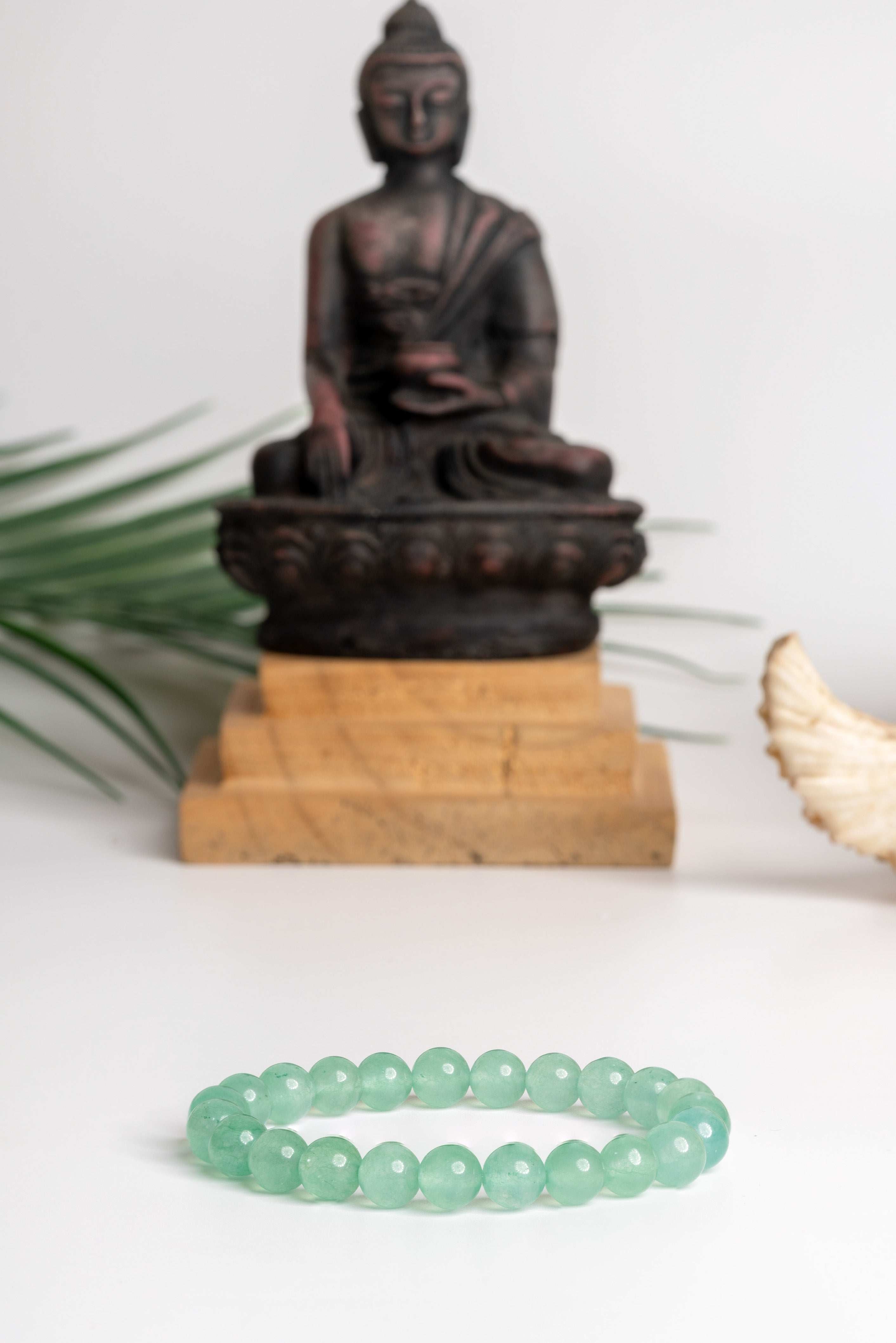 Green Aventurine Bracelet by LOOK AND ADORN set against a serene Buddha statue backdrop