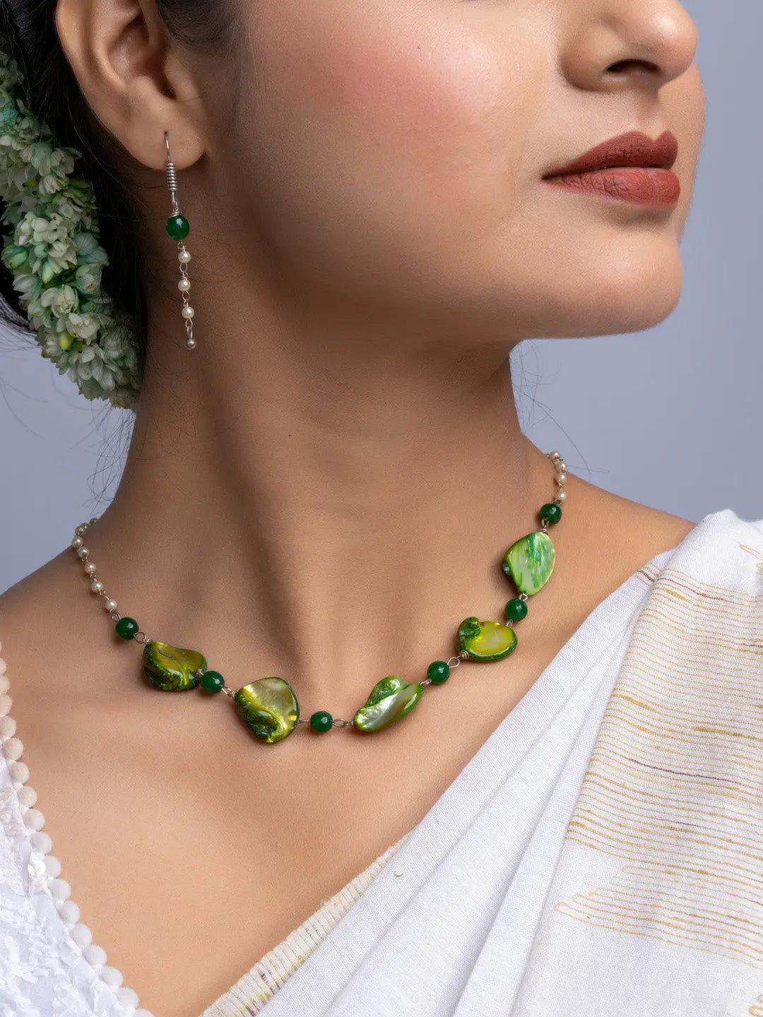 Handmade mother of pearl necklace set with green and pearl beads worn with traditional attire
