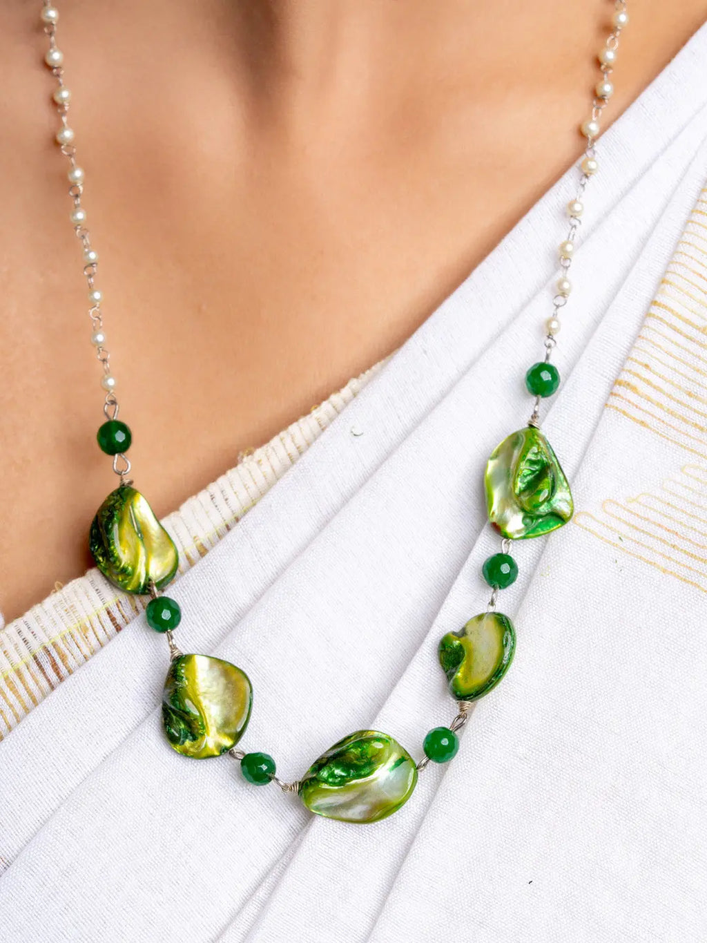 Handmade mother of pearl necklace set featuring green and gold shell beads with small green accents