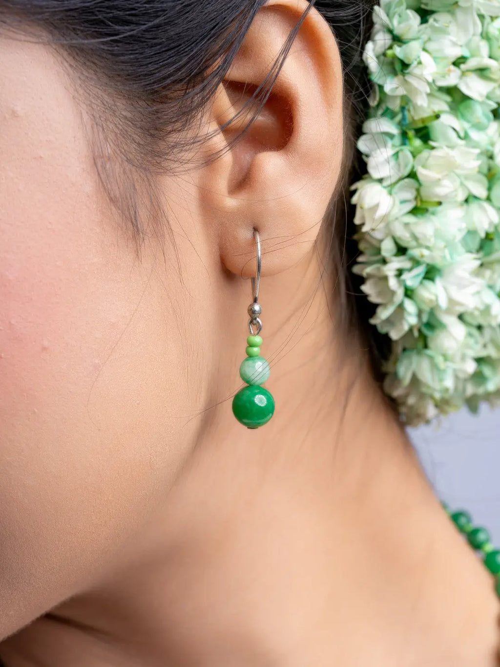 Handmade green onyx necklace earring with silver hook worn by woman with floral hair accessory