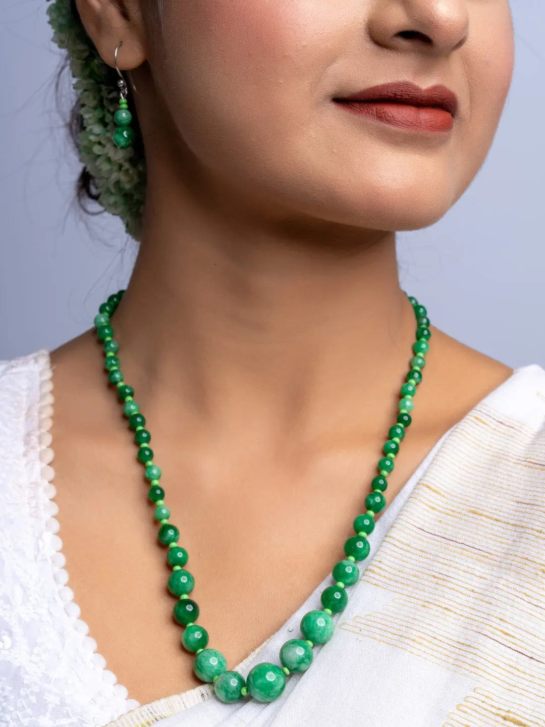 LOOK AND ADORN handmade green onyx necklace with matching earrings worn on woman in white attire