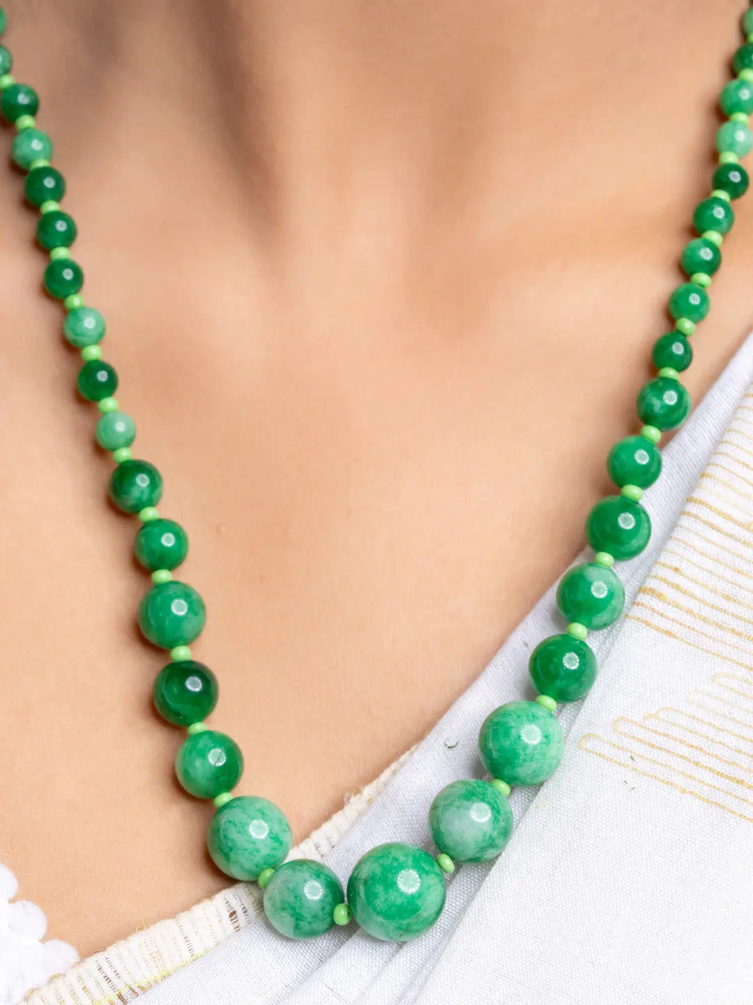 Handmade green onyx necklace with round polished beads worn around the neck