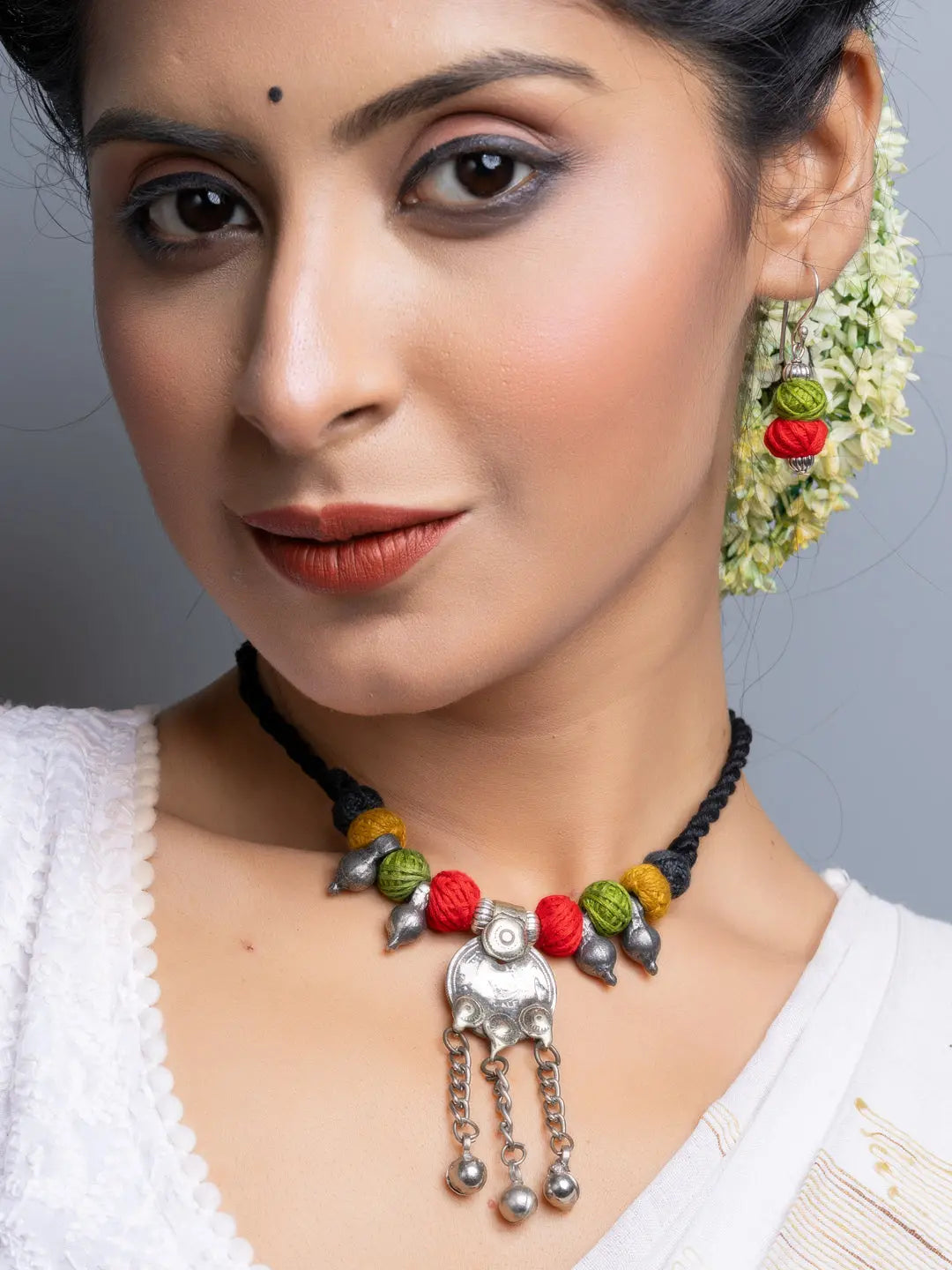 Woman wearing a colorful afghani necklace set with silver pendant and beads by LOOK AND ADORN