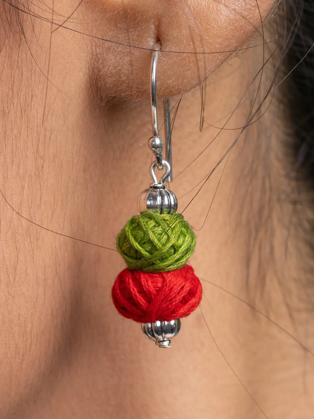 Close-up of a colorful afghani necklace set green and red thread ball earring by LOOK AND ADORN