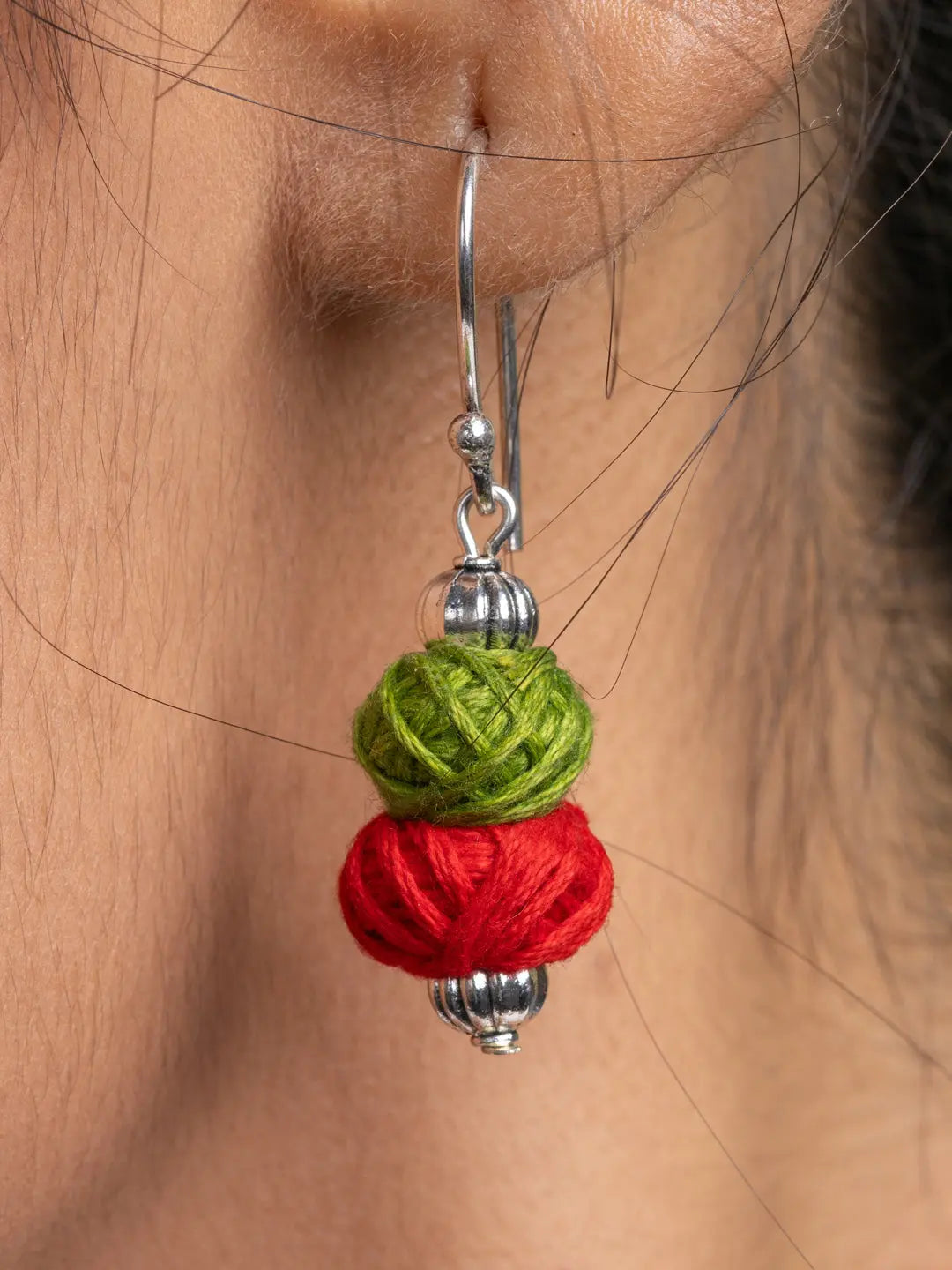 Close-up of a colorful afghani necklace set green and red thread ball earring by LOOK AND ADORN