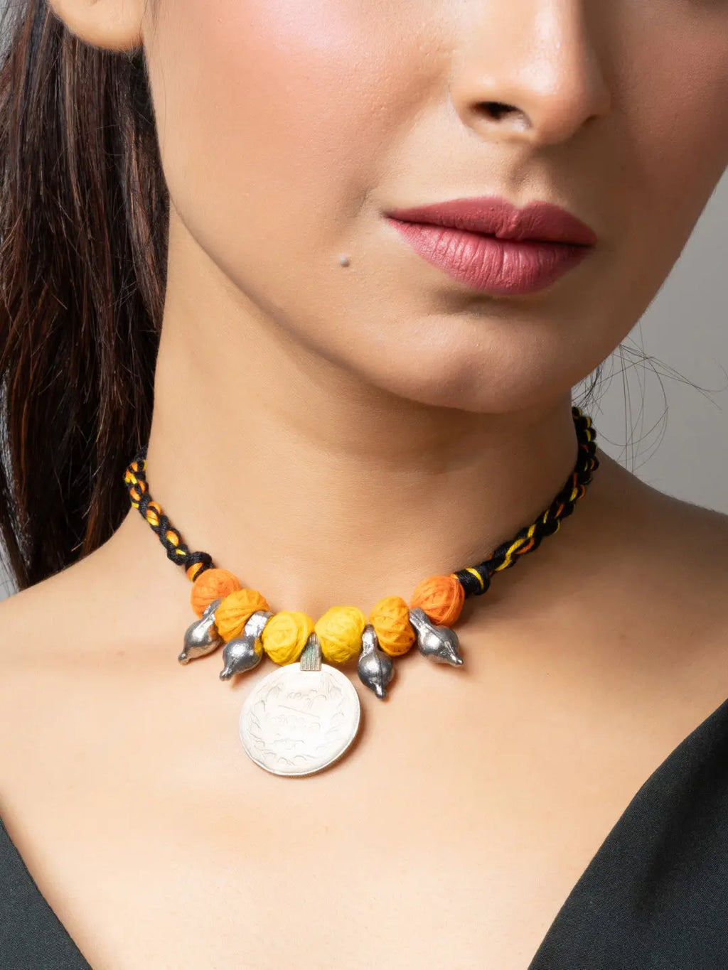 Afghani pendant necklace with yellow and orange beads and silver charms from LOOK AND ADORN