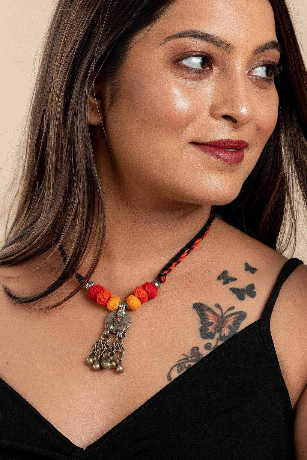 Afghan Tibetan brass oxidised silver necklace with colorful beads worn by woman showcasing handmade jewelry