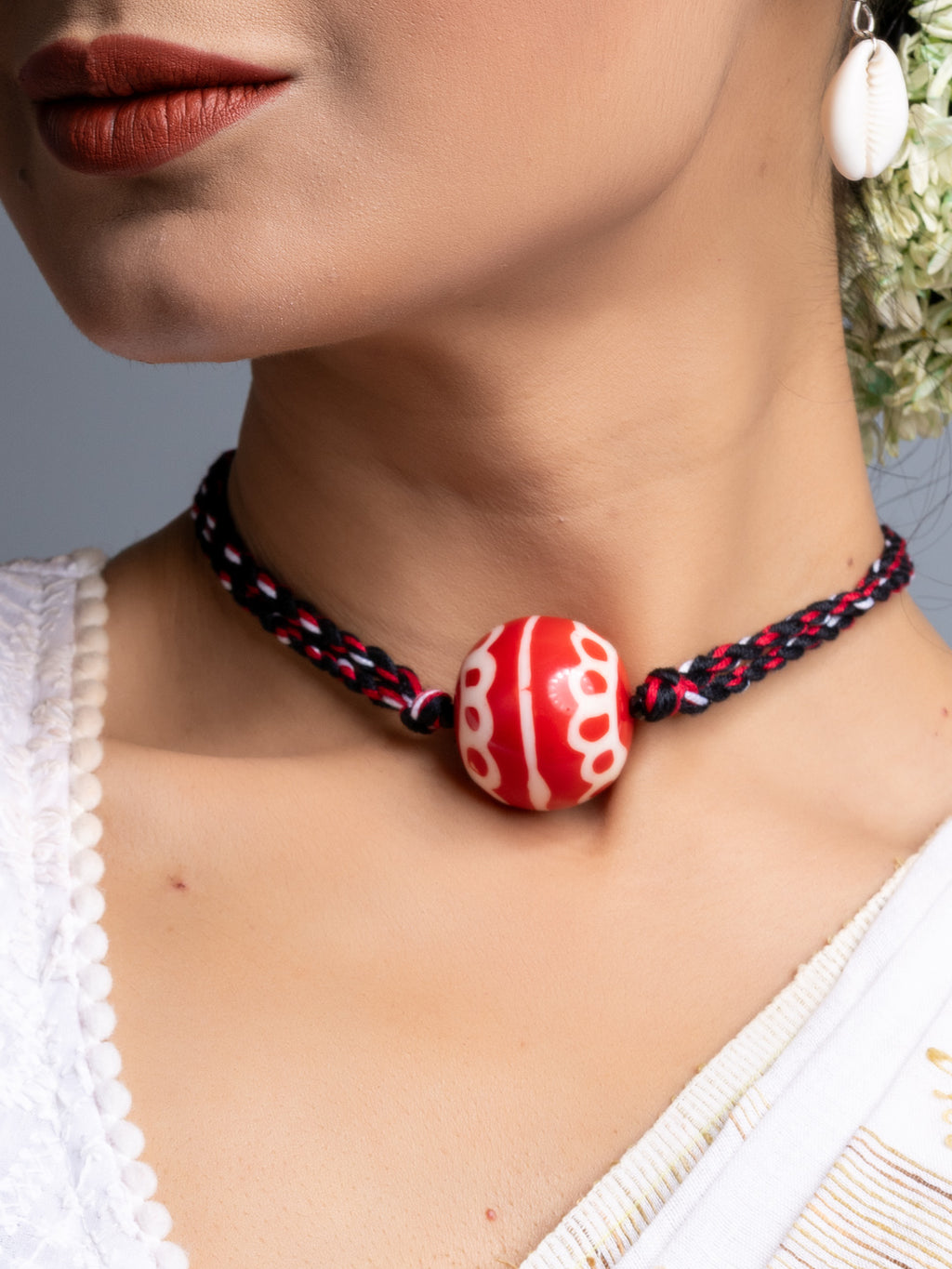 Handmade necklace set featuring red and white bead on black braided cord by LOOK AND ADORN