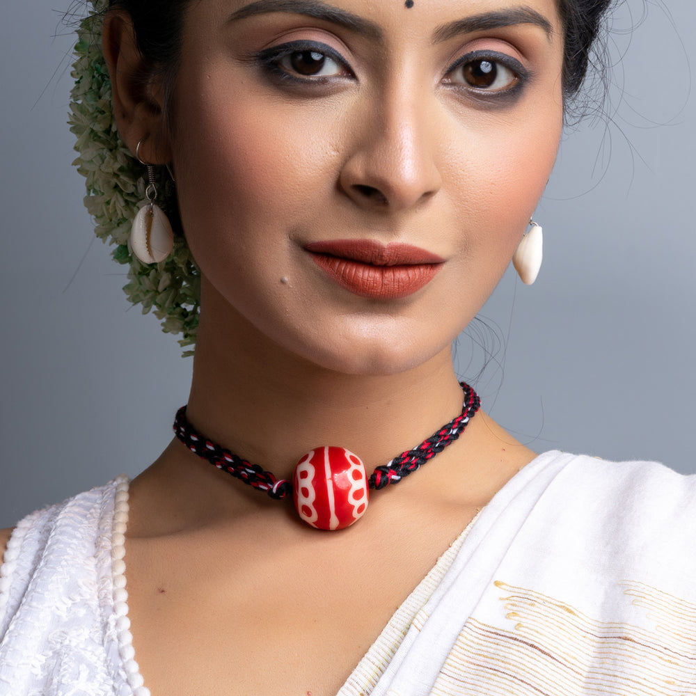 Handmade necklace set featuring a red bead pendant on black and red braided cord by LOOK AND ADORN