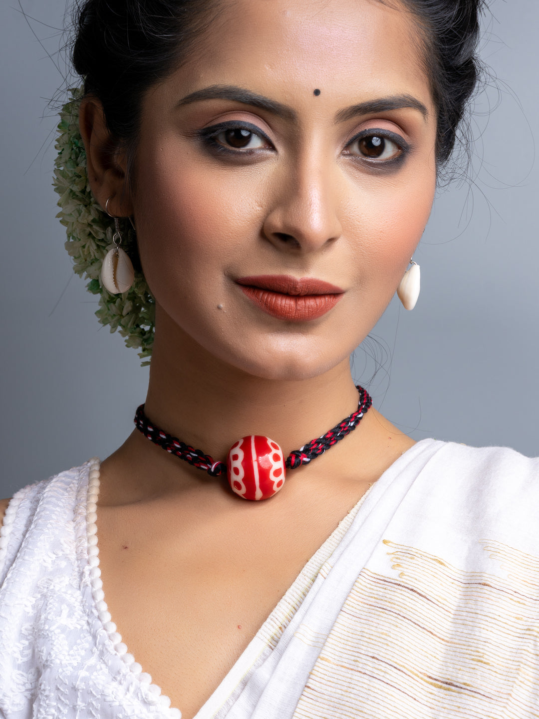 Handmade necklace set featuring a red bead pendant on black and red braided cord by LOOK AND ADORN