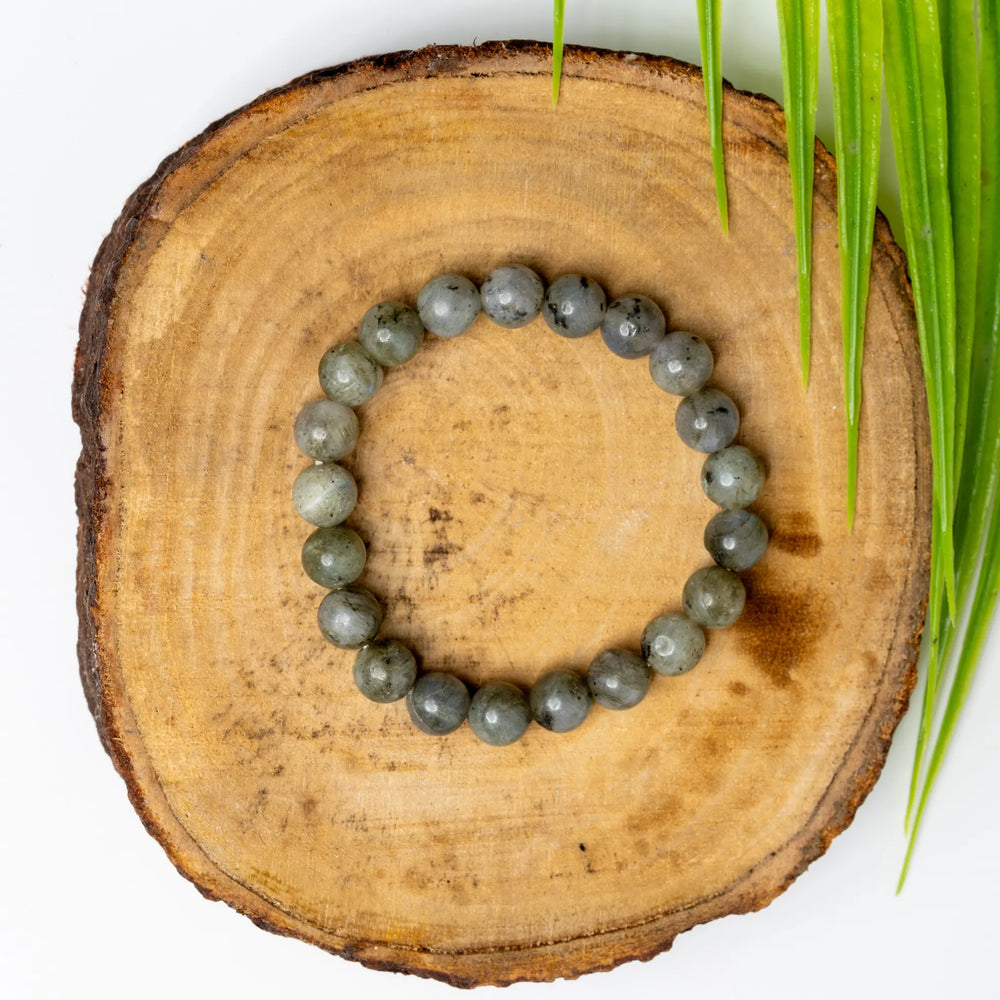 Labradorite bracelet from LOOK AND ADORN featuring smooth, round gemstones on a natural wood surface