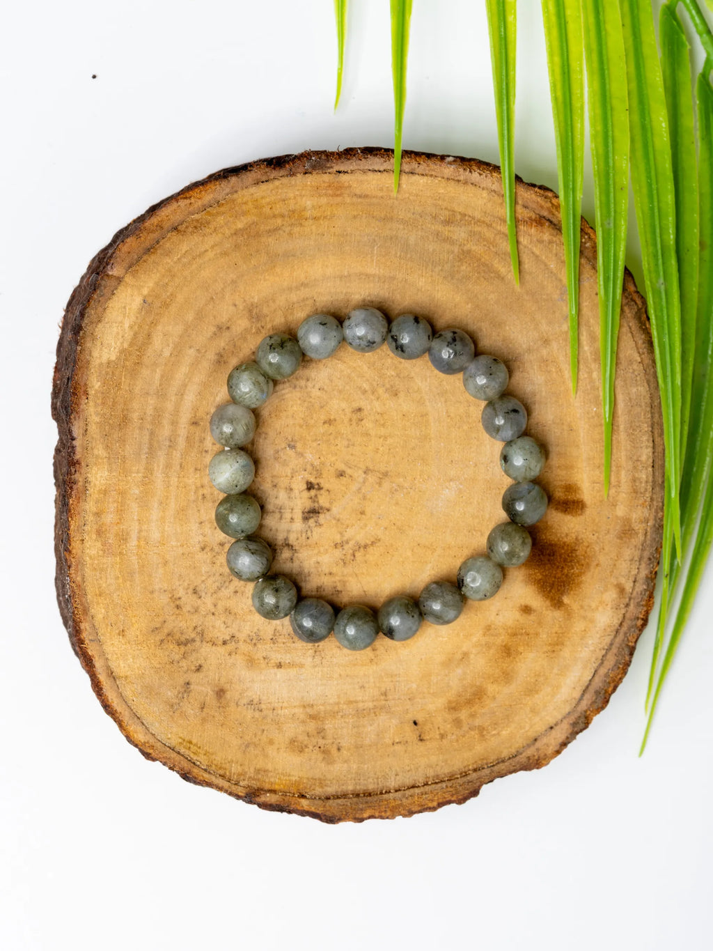 Labradorite bracelet from LOOK AND ADORN featuring smooth, round gemstones on a natural wood surface