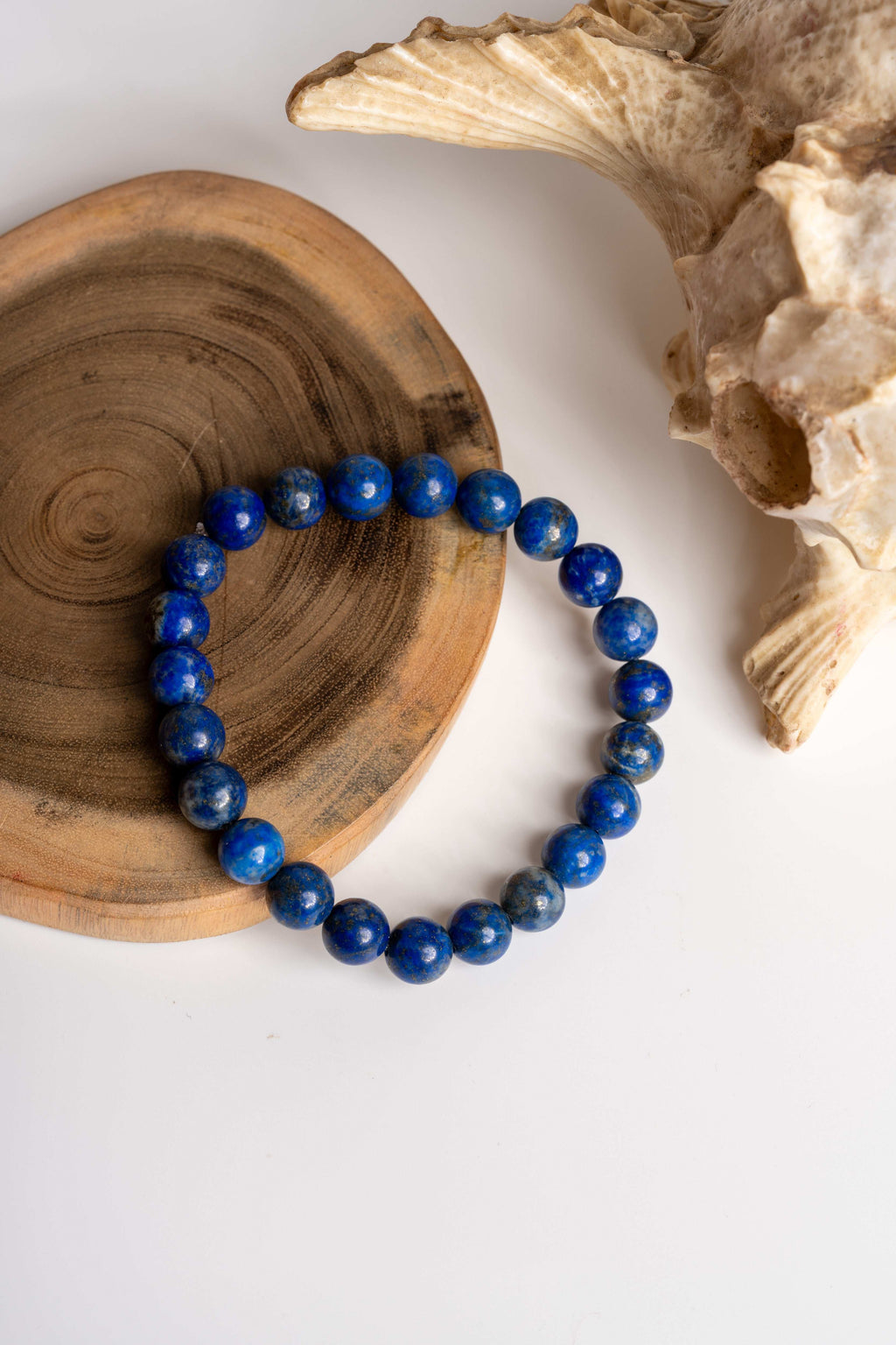 Lapis lazuli bracelet on a wooden surface with natural textures for elegant jewelry styling