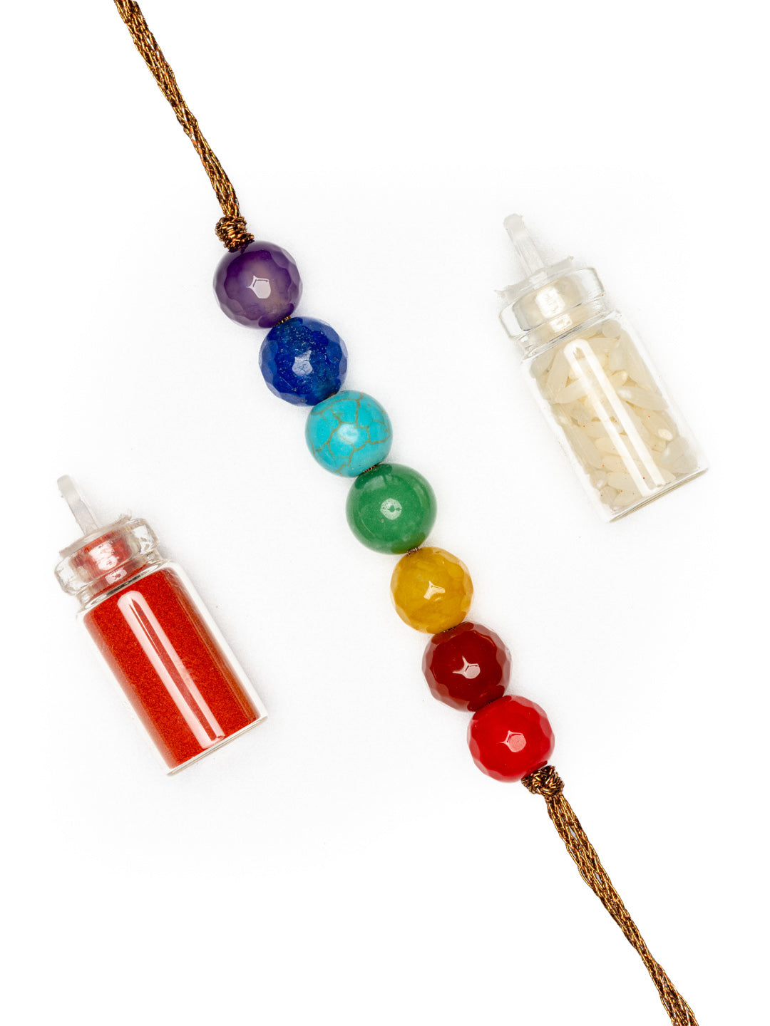 7 chakra rakhi with seven colorful beads and two small bottles of red and white powder