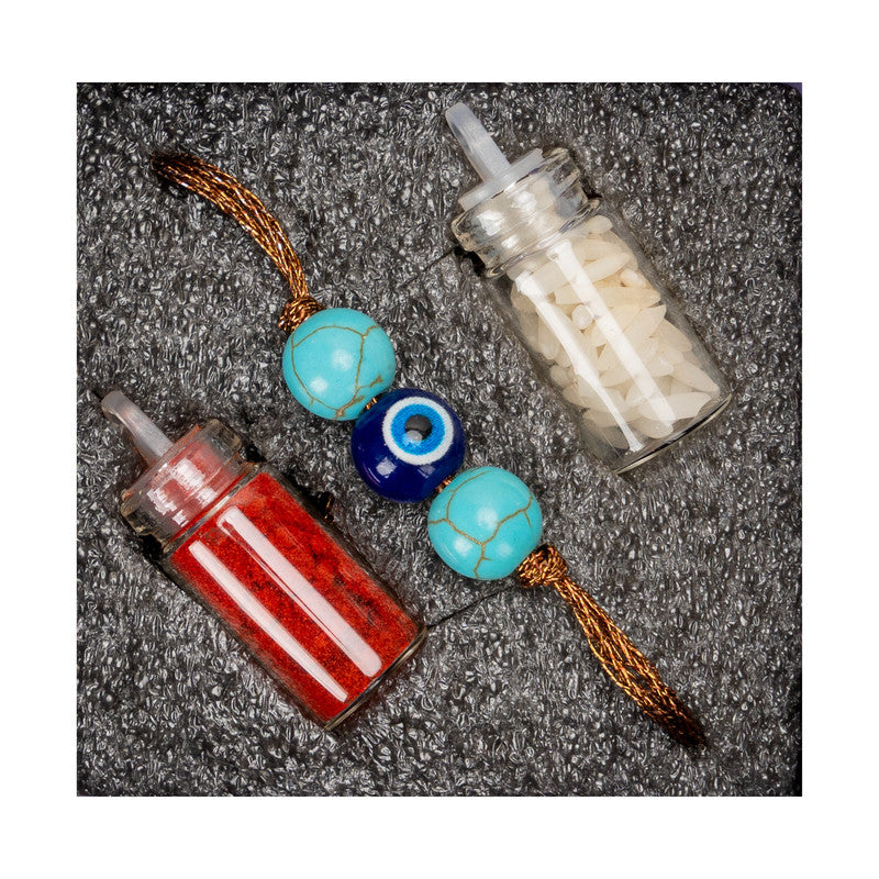 LOOK AND ADORN evil eye rakhi with blue and turquoise beads and sacred red and white powders