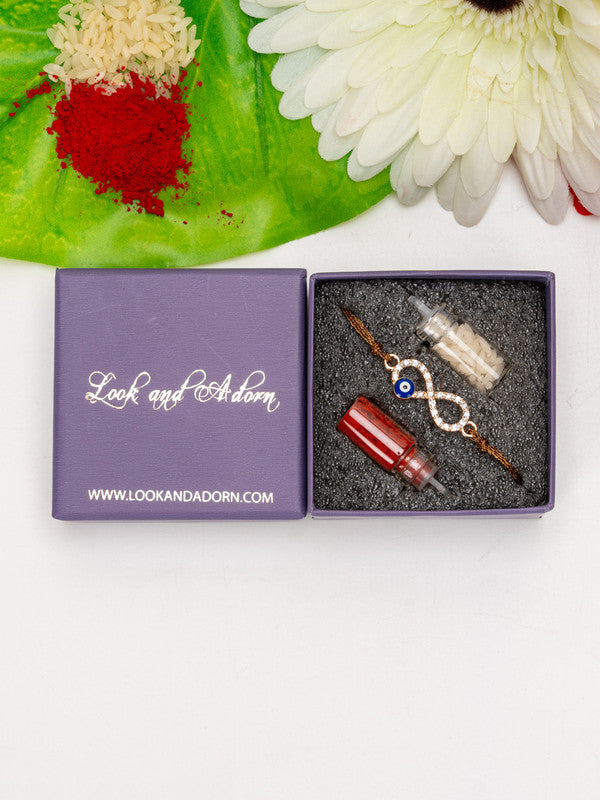 LOOK AND ADORN evil eye rakhi with red and white bottles in a purple gift box on white background