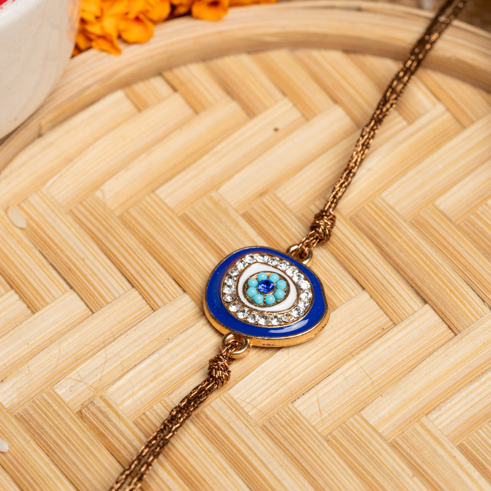 LOOK AND ADORN evil eye rakhi with blue and white stones on a golden chain for protection