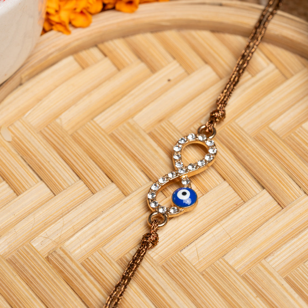LOOK AND ADORN evil eye rakhi with crystal-studded infinity symbol and blue evil eye charm