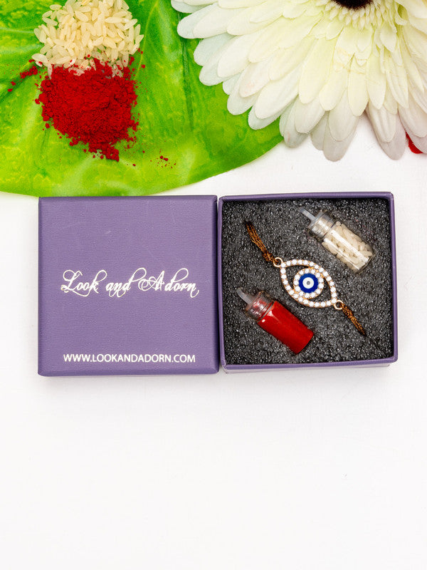 Evil eye rakhi with red and white powders and rice in Look and Adorn gift box