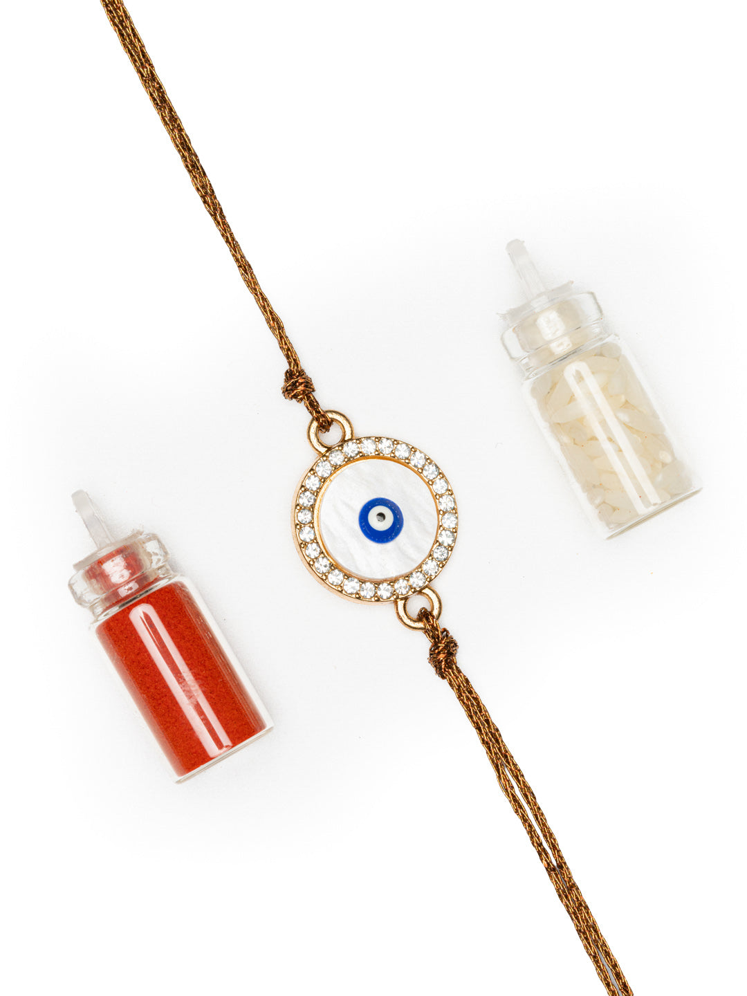 LOOK AND ADORN evil eye rakhi with white stones and brown thread alongside red and white powder bottles