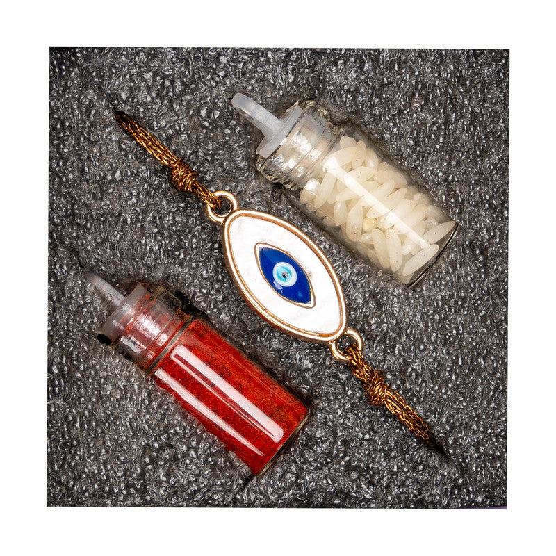 LOOK AND ADORN evil eye rakhi with red and white thread powders on textured black background