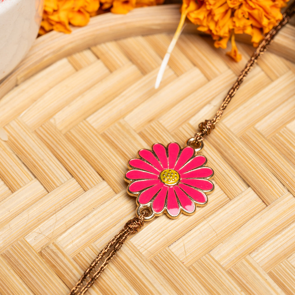 LOOK AND ADORN floral rakhi with pink flower design and golden chain on wooden background