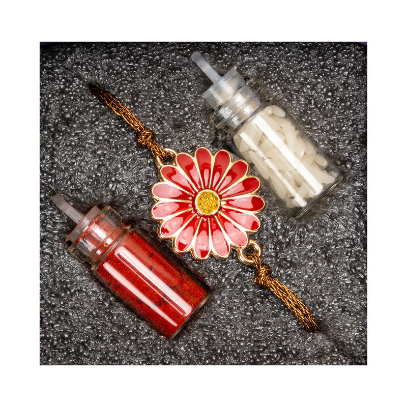 LOOK AND ADORN floral rakhi with red and white decorative bottles on textured background