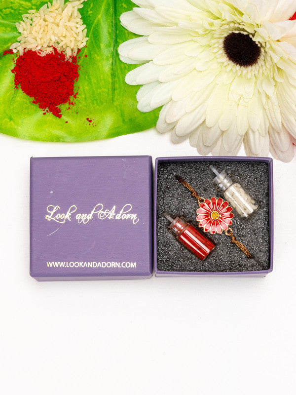 Floral rakhi with red and white decorative elements in a Look and Adorn purple gift box