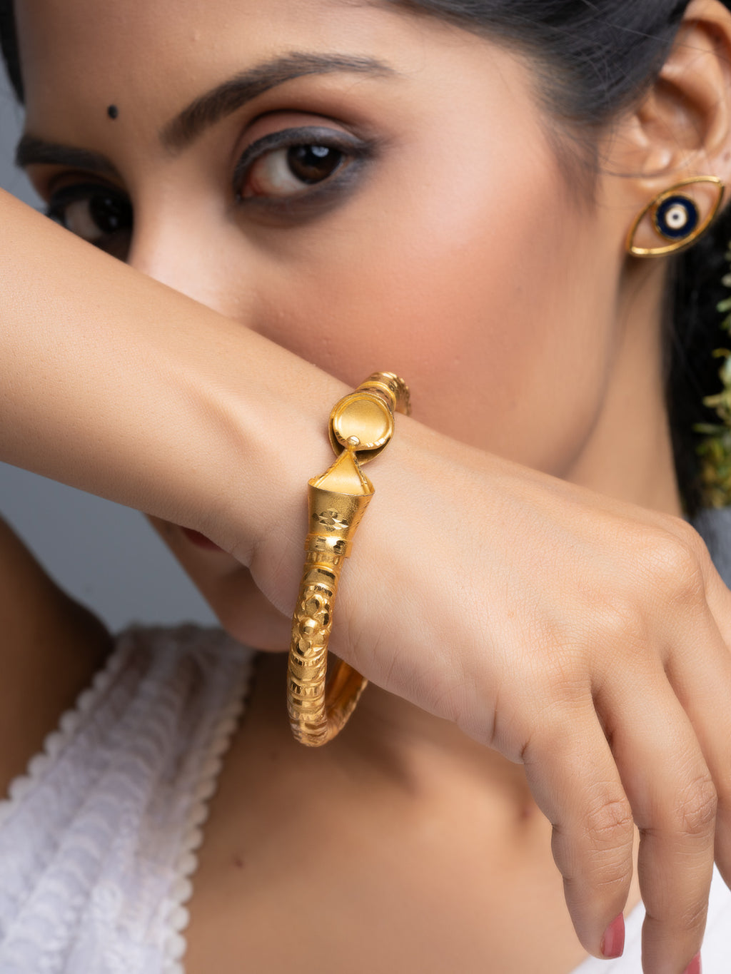 LOOK AND ADORN gold plated bangle worn on model wrist ornate textured traditional design