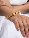 LOOK AND ADORN gold plated bangle on a female wrist textured hammered design with polished clasp detail