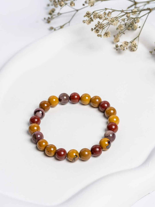 Mookaite Jasper Bracelet featuring vibrant red, yellow, and brown stones in a stretchy style for everyday wear
