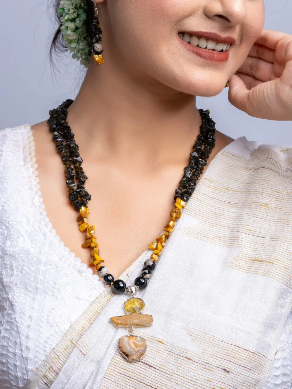 Handmade Mother of Pearl Necklace Set with black and yellow beads worn with traditional white saree