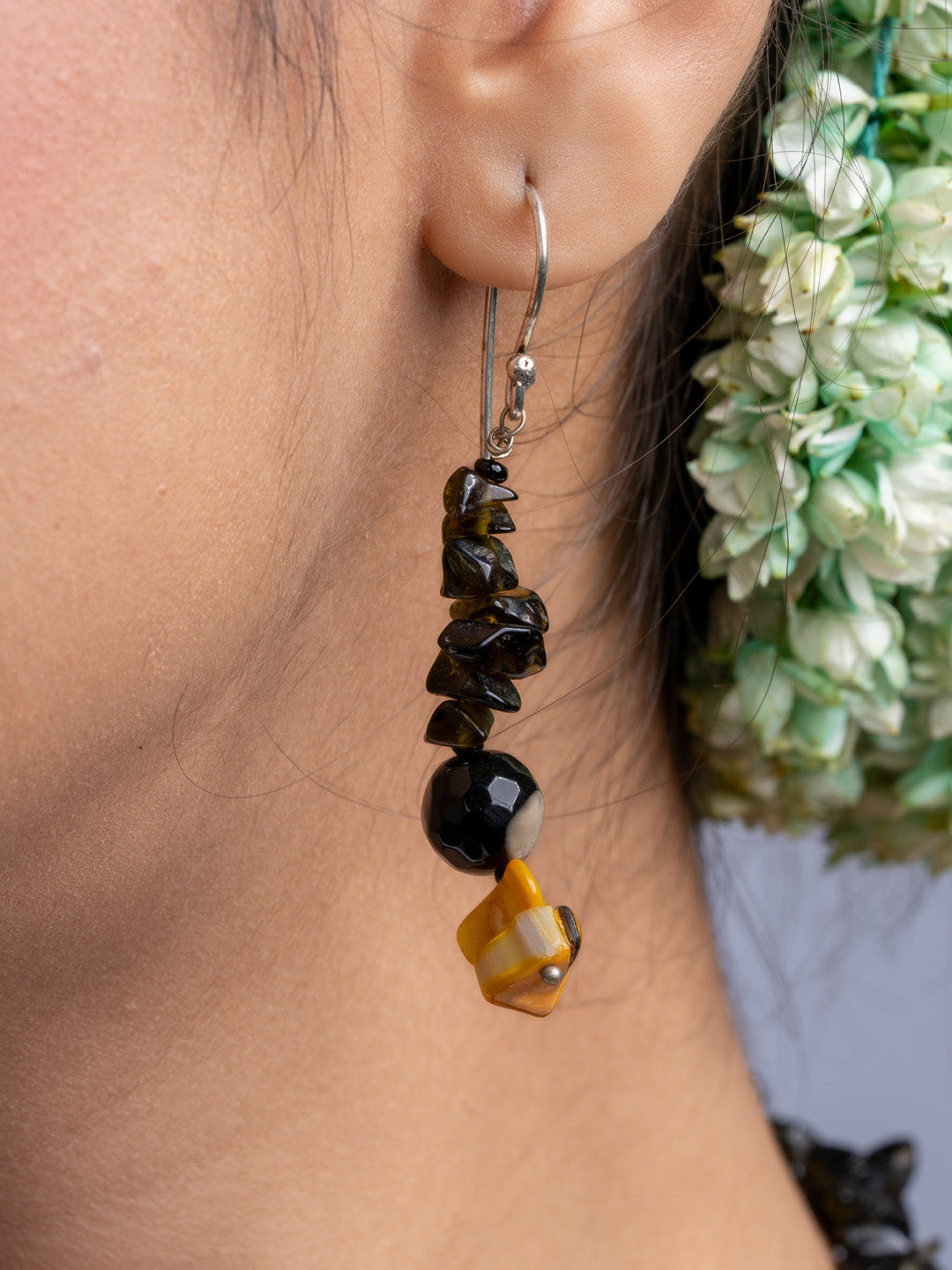 Handmade Mother of Pearl Necklace Set earring featuring black and amber beads worn on ear