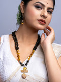 Handmade Mother of Pearl Necklace Set featuring black and amber beads worn by woman in white dress
