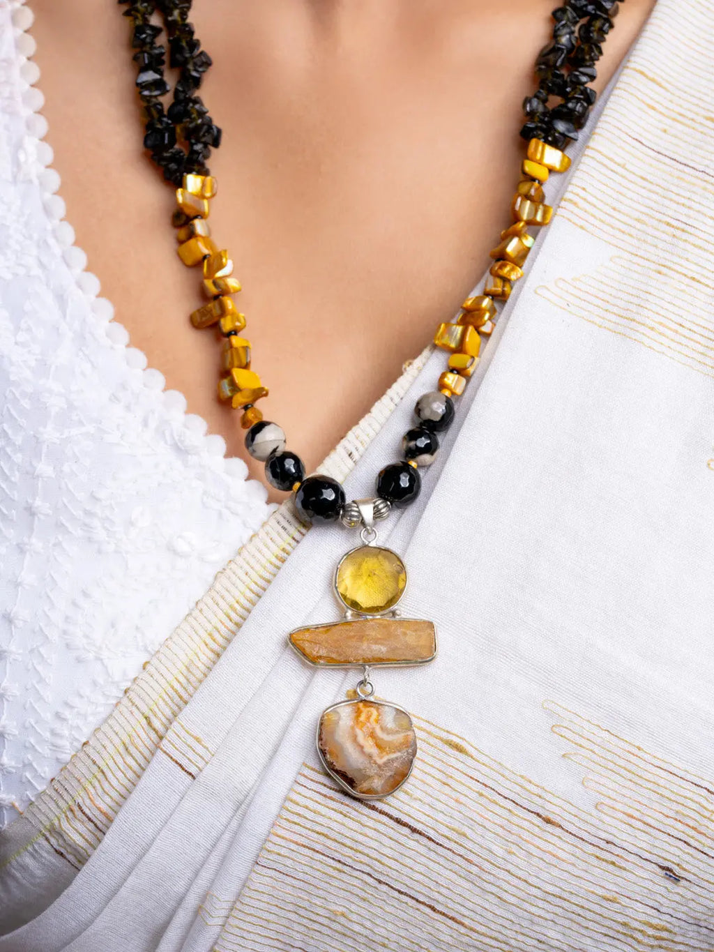 Handmade Mother of Pearl Necklace Set with black and gold beads worn with white and gold sari