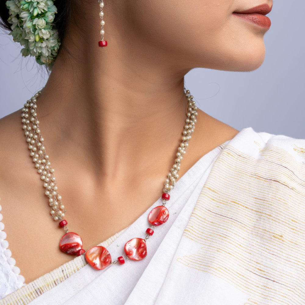 LOOK AND ADORN handmade mother of pearl necklace set with red accents worn with white traditional attire