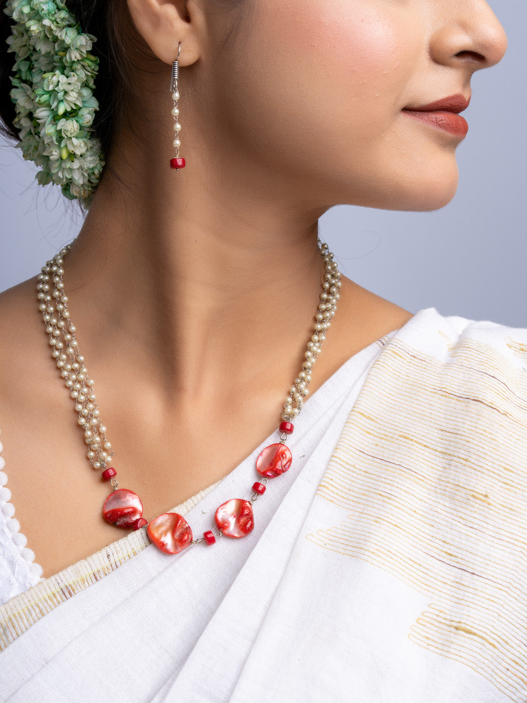 LOOK AND ADORN handmade mother of pearl necklace set with red accents worn with white traditional attire