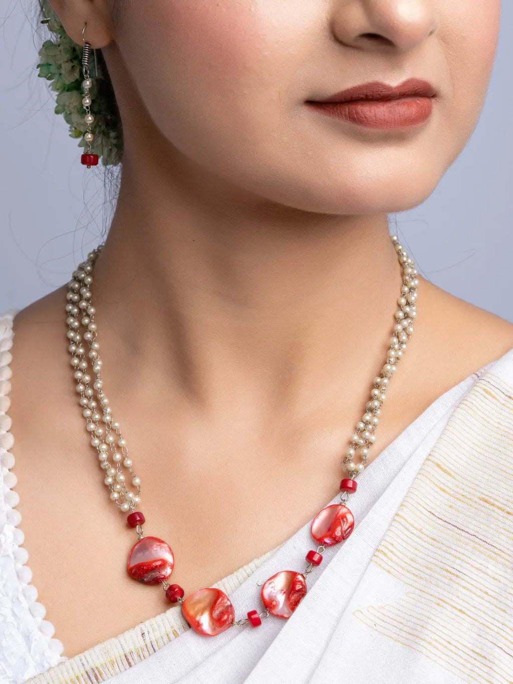 Handmade mother of pearl necklace set with red and white beads worn with traditional attire