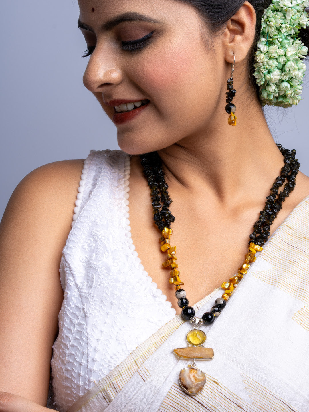Handmade Mother of Pearl Necklace Set with black and amber beads worn with traditional white saree