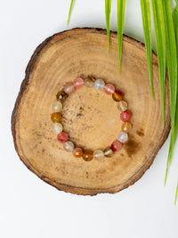 Multi Cherry Quartz Bracelet on a wooden surface with natural texture for stylish adornment