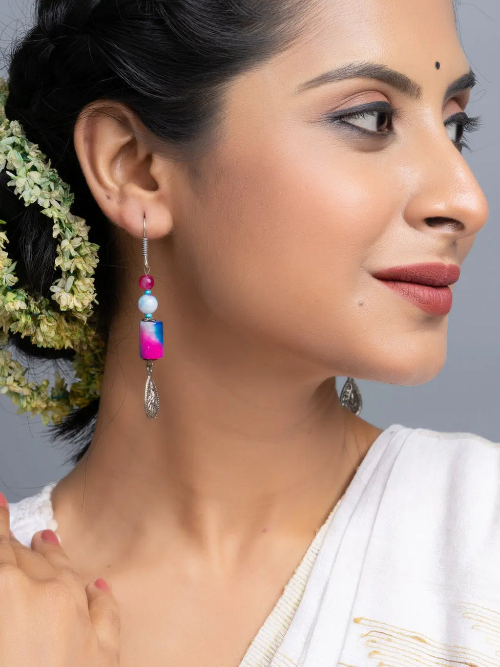 Woman wearing handmade onyx earrings with blue and pink beads by LOOK AND ADORN