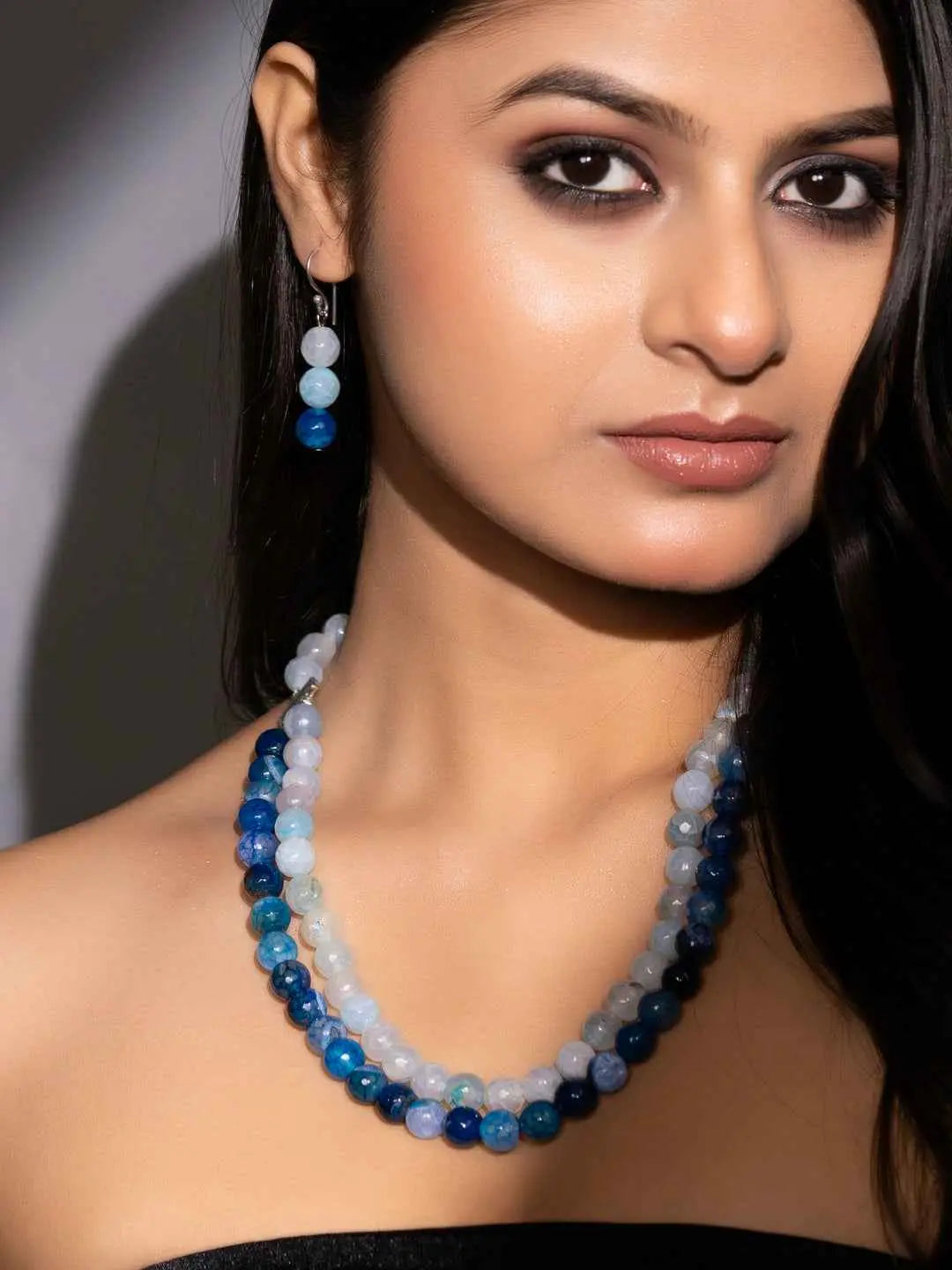 Handmade onyx necklace set featuring blue and white agate beads with matching earrings
